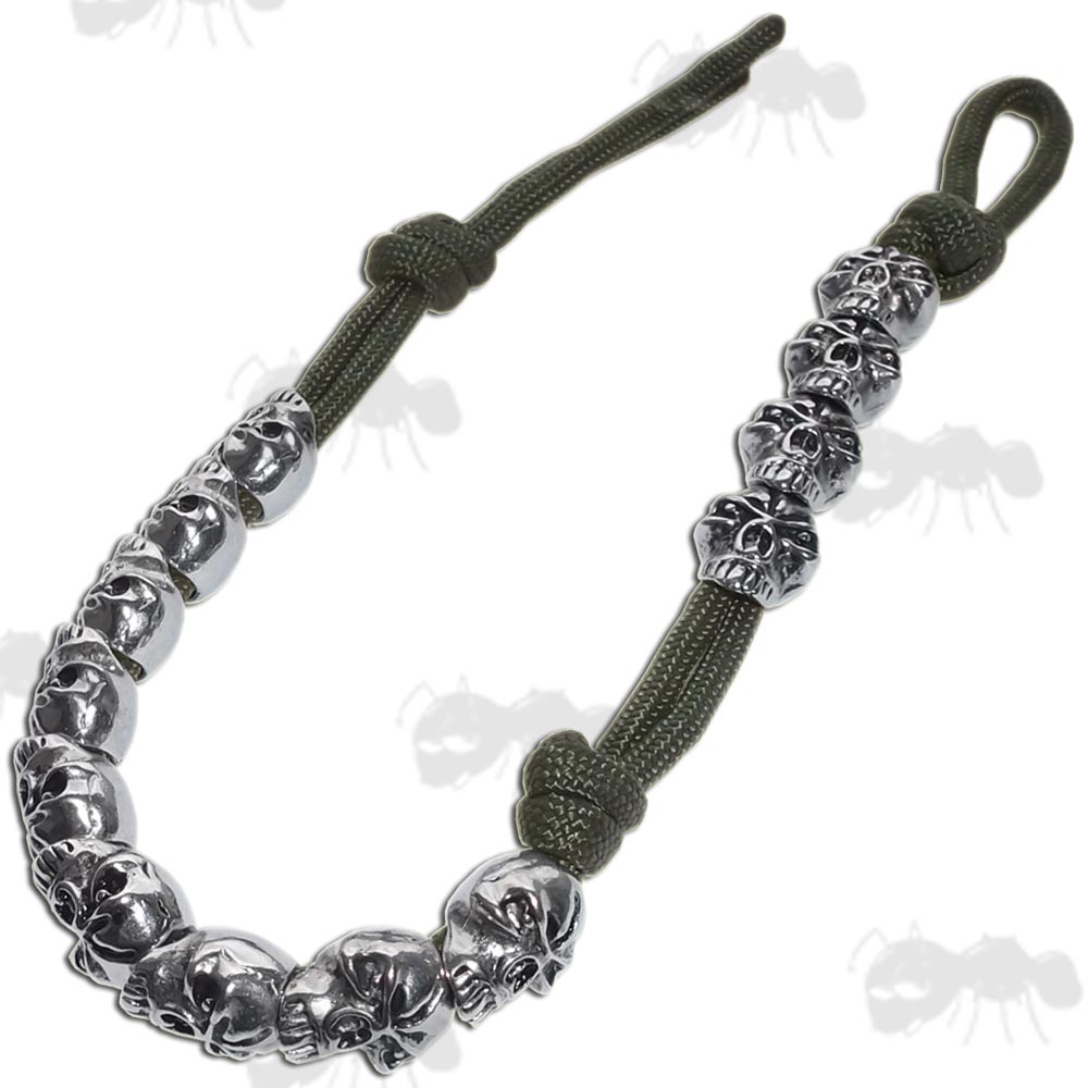 Thirteen Silver Coloured Metal Pace Counter Skulls on Green Paracord