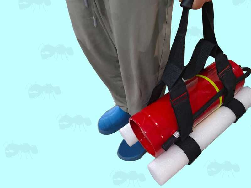 PCP Airgun Cylinder Carry Handle with White Foam Anti-Roll Cradle, Shown Carrying a Red Fire Extinguisher