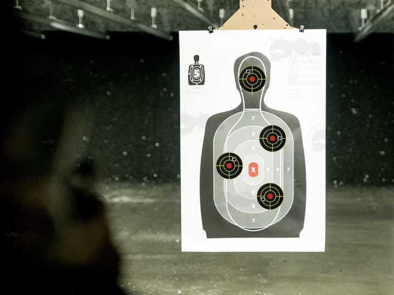 Roll of 200 Circular Self Adhesive Reactive Yellow and Black Paper Shooting Target with Full Circle Bullseye, Shown in Use at Firing Range