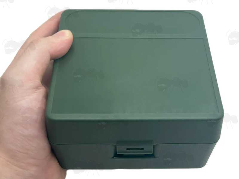Green Plastic Shotgun Cartridge Box for 25 x 12g Shells, Shown Closed in Hand