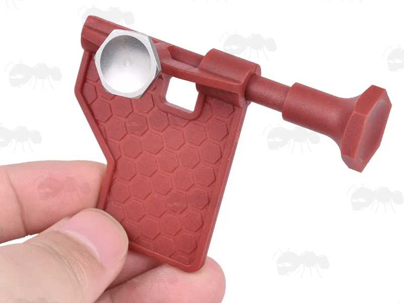 Red Plastic Pivot Pin Detent Takedown Installation Tool for .223 5.56mm Rifles, Shown in Hand
