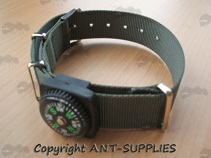 Button Compass with Buckle Strap Fitting On a Green Watch Strap