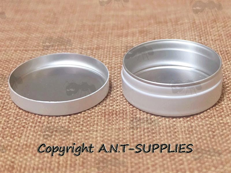Opened View Of a Small Survival Tin Jar with Push Top Lid and White Enamel Coating