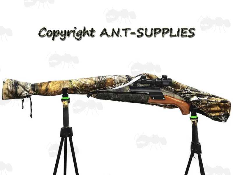 Elasticated Rim Tree Camouflage Patterned Rifle Cover Slip Hood, Shown Over Rifle on Tripod Rests