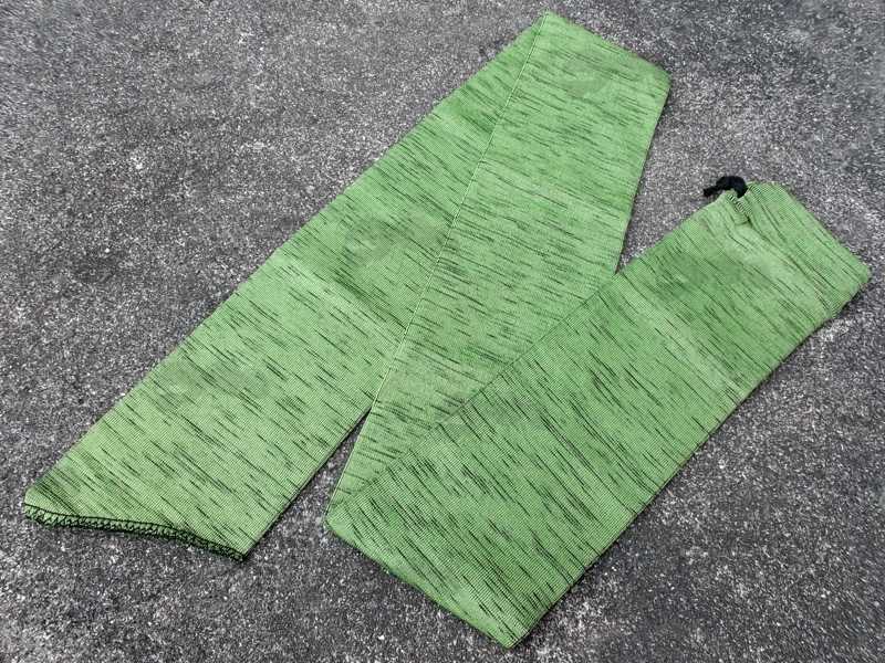 Bright Green Coloured Silicone Coated Gun Cover Sock, Shown Fitted on a Rifle