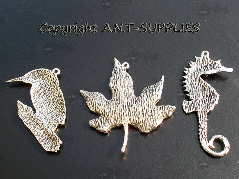 Back View Of Three Pewter Pendants