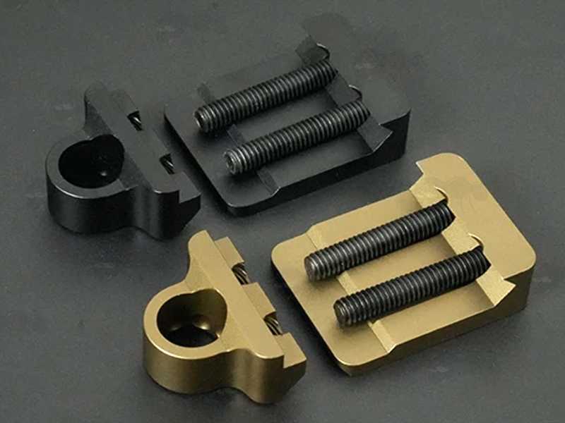 Base Fitting View of One Black and One Tan Coloured Offset Side Release QD 10mm Socket with 20mm Rail Mount