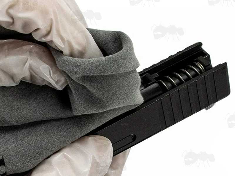 Grey Coloured Silicone Cleaning Cloth, Shown Cleaning Pistol Slide