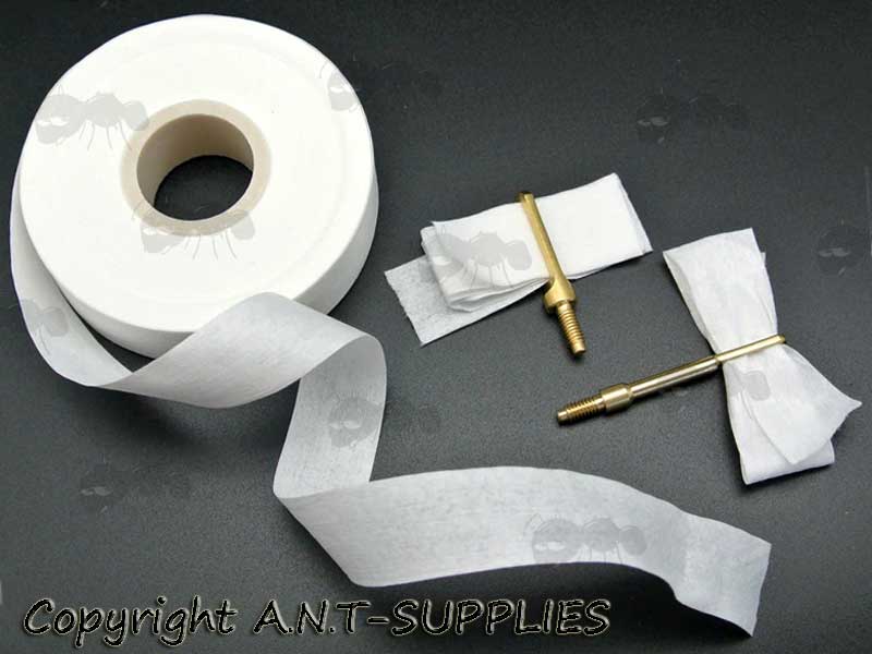 Roll of 20mmx30m AnTac Synthetic Gun Barrel Non-Woven Cloth Shown with Patch Cut Offs and Two Brass Patch Pullers