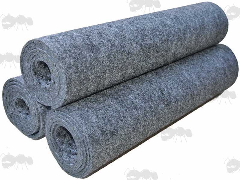 Three Rolled Up Antac Grey Non-Slip Fabric Gun Maintenance Mats