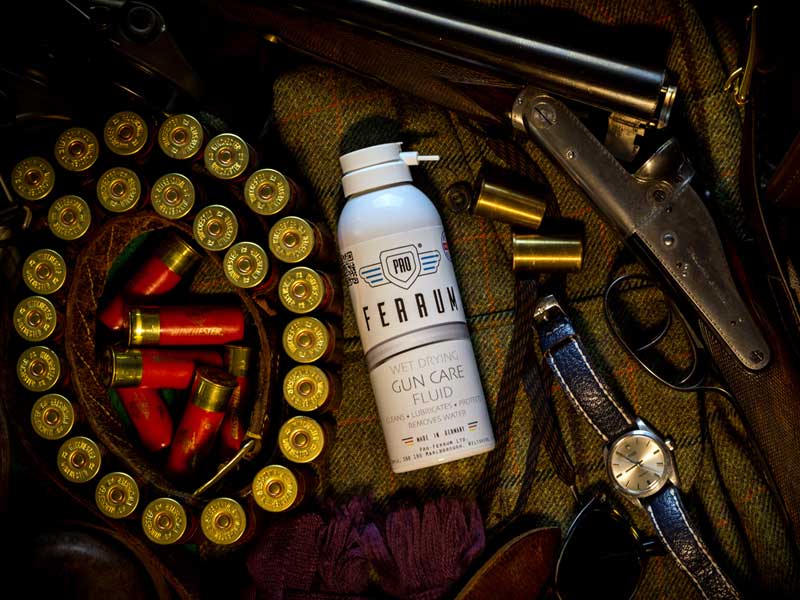 Spray Can of Pro Ferrum Gun Oil With Shotgun and Shotgun Cartridge Belt
