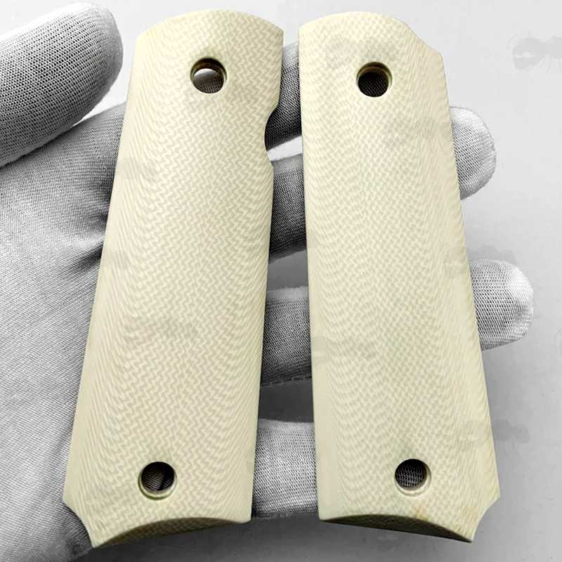 Pair of Full Size White Ivory Resin 1911 Pistol Grips with a Smooth Finish, Shown in Gloved Hand