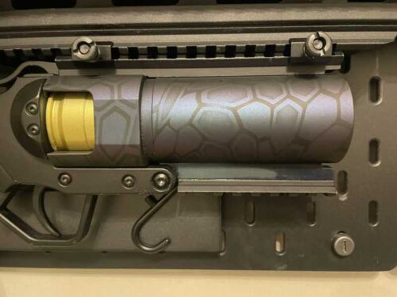 Pair of Weaver to Weaver Rail Adapter Clamps Joining Two Weaver Rails to Secure a Grenade Launcher