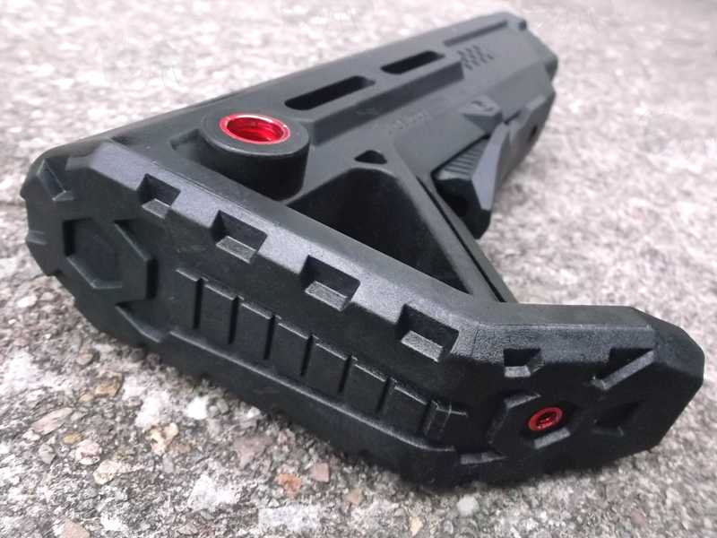 Shoulder Fitting Section View of The Black M4 Style Collapsible Tactical Rifle Buttstock, with a Red 10mm Push Button Flush Fit QD Sling Swivel Socket