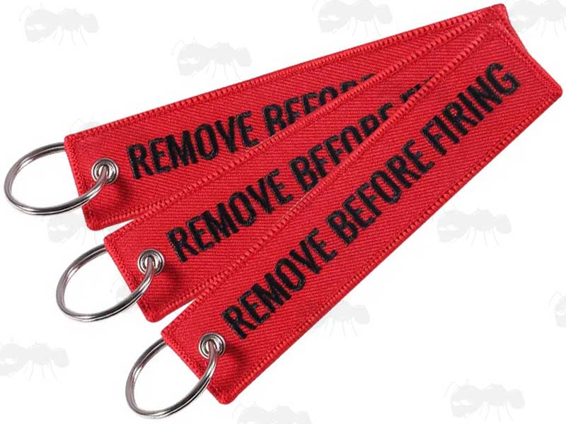 Three Red Gun Safety Keyrings with Embroidered Black Thread Remove Before Firing Text