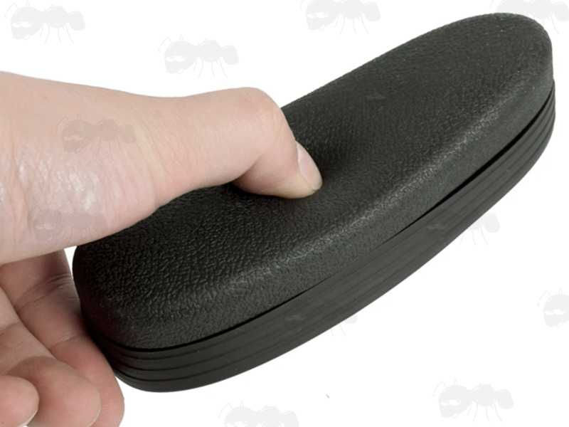 M4 Retractable Stock Black Rubber Recoil Butt Pad with Textured Finish, Shown with Thumb Depressing The Pad