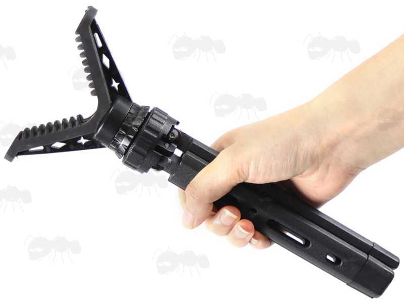 Folded View of The Compact Black Metal Tripod Benchrest Shooting Quick Stick with Removable V Notch Rest, Shown in Hand