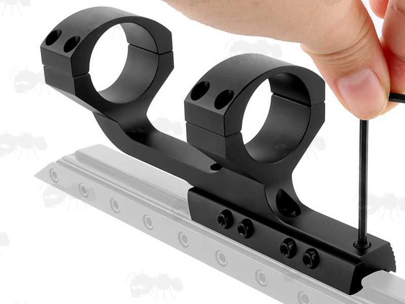 Base View of The Extended Reach One Piece Dovetail Rail Scope Mount for 30mm Scope Tubes, with Three Scope Creep Stopper Grub Screw Pins, Shown On a Rail with Recoil Pin Being Adjusted