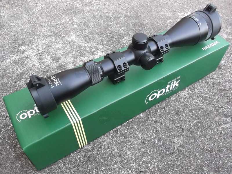 Richter Optik 3-9x42AO Adjustable Magnification Rifle Scope with Pair of Dovetail Mounts Fitted, Shown on Top of it's Green Cardboard Retail Box