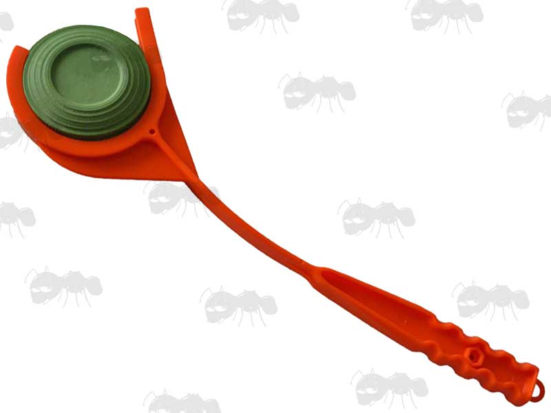 Bright Orange Polymer Hand Held Clay Pigeon Thrower Loaded With Green Clay Pigeon